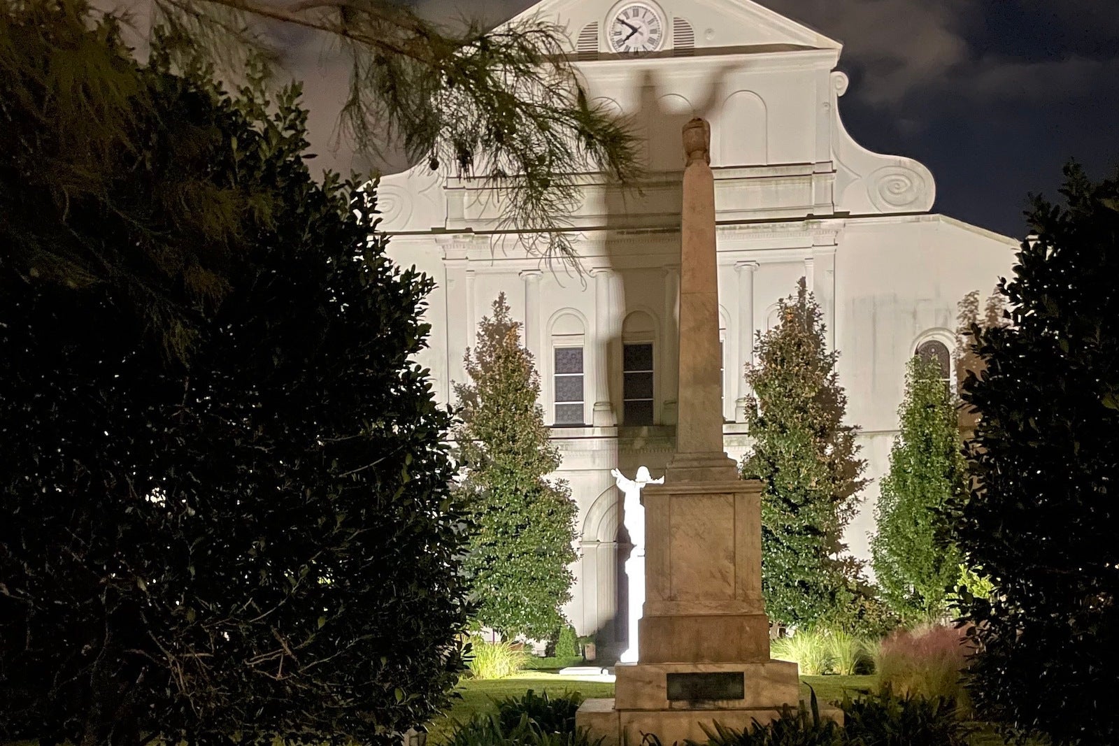 shadow of statue projecting onto large white building