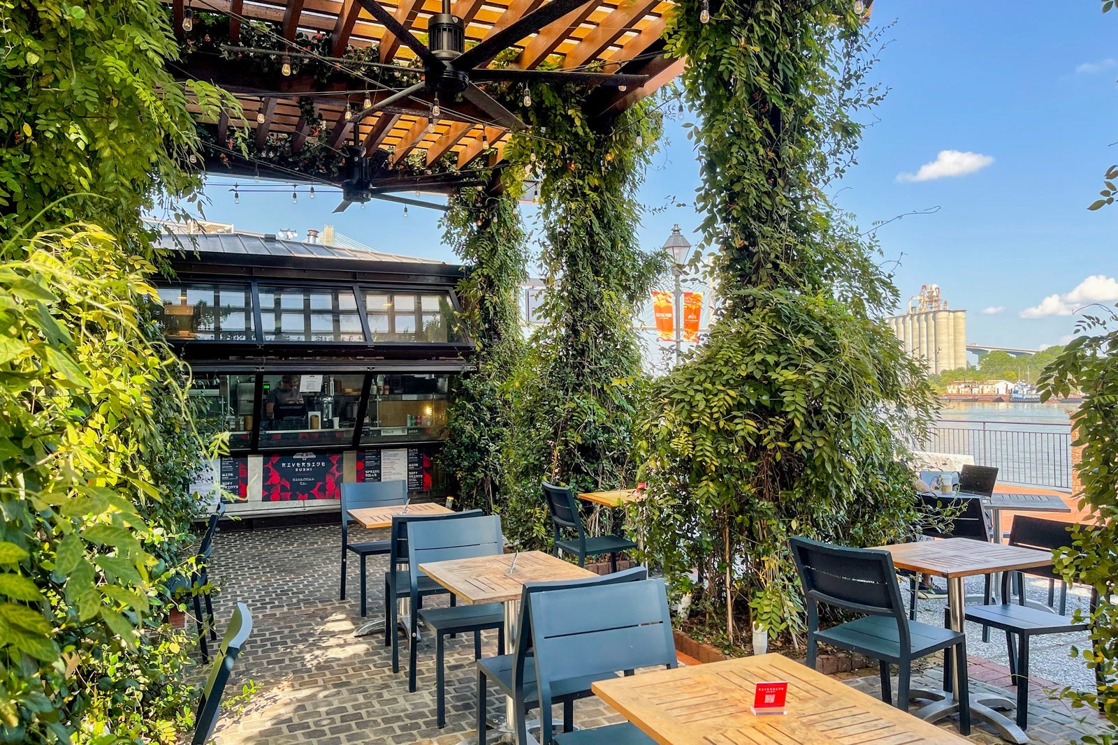 An outdoor dining area surrounded by plants