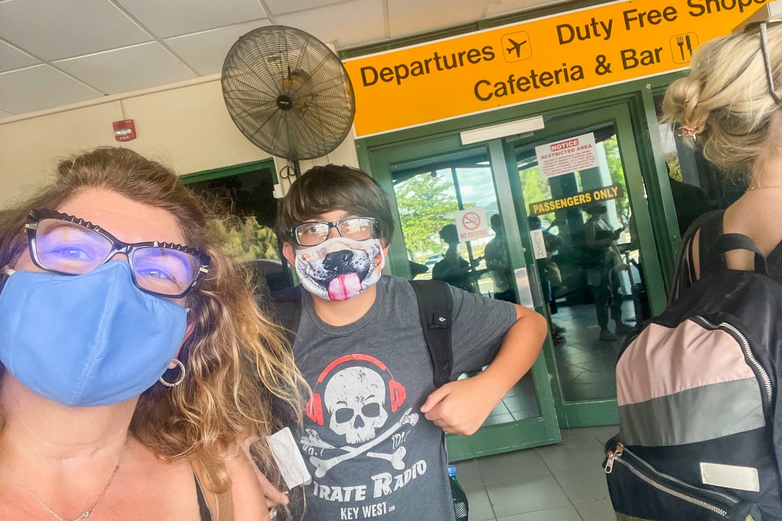 Chris's wife and son at the airport getting to go home after quarantine