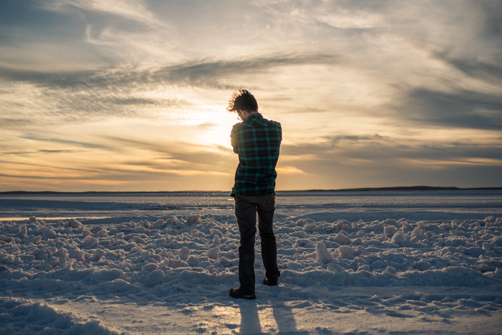 Man stands in the sand as the sun sets in Guerrero Negro
