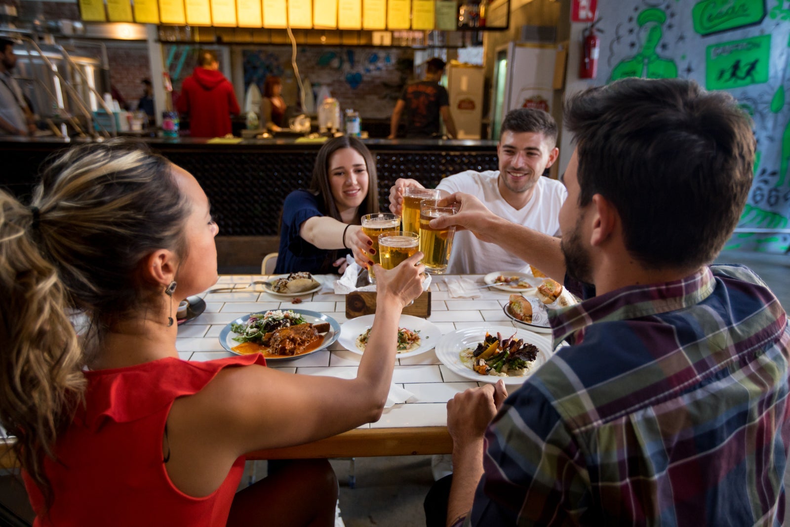 Friends toasting drinks at a restaurant in Tijuana, Mexico