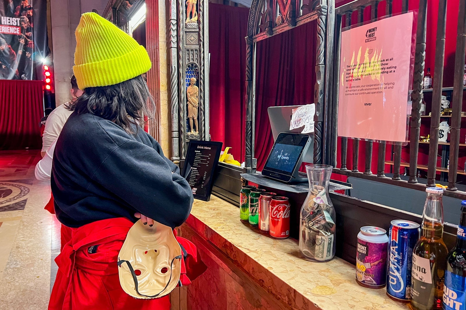 Mimi ordering a drink from the bar