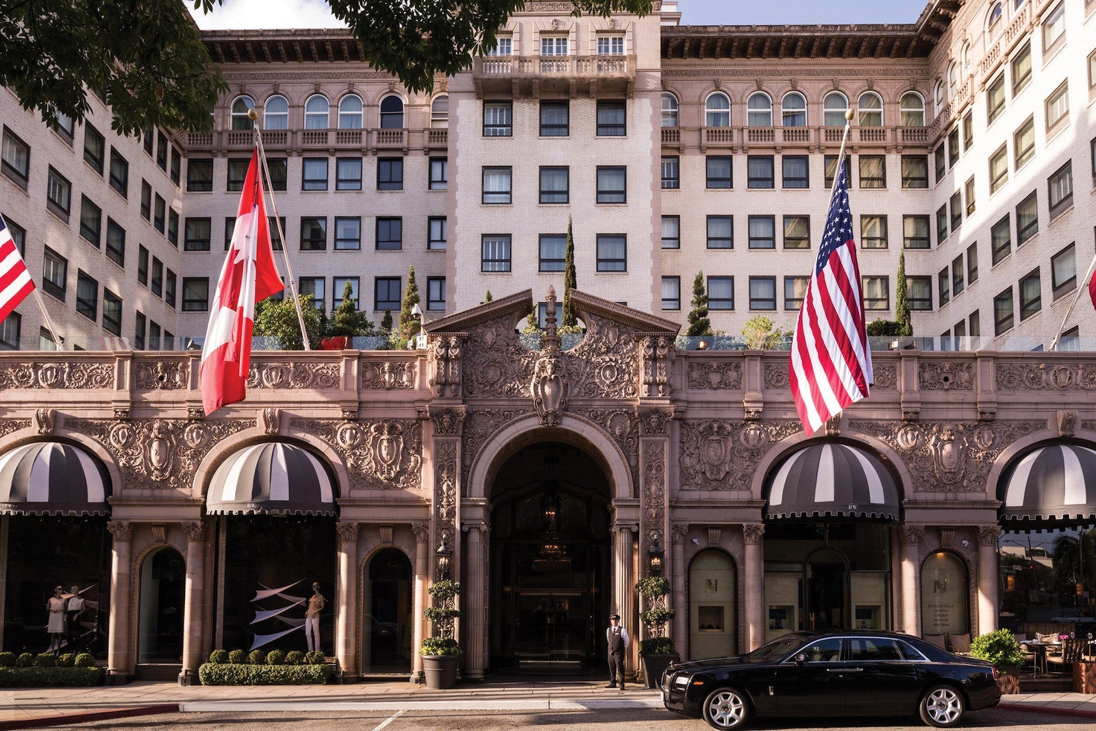 exterior image of grand hotel with American and Canadian flags above entrance