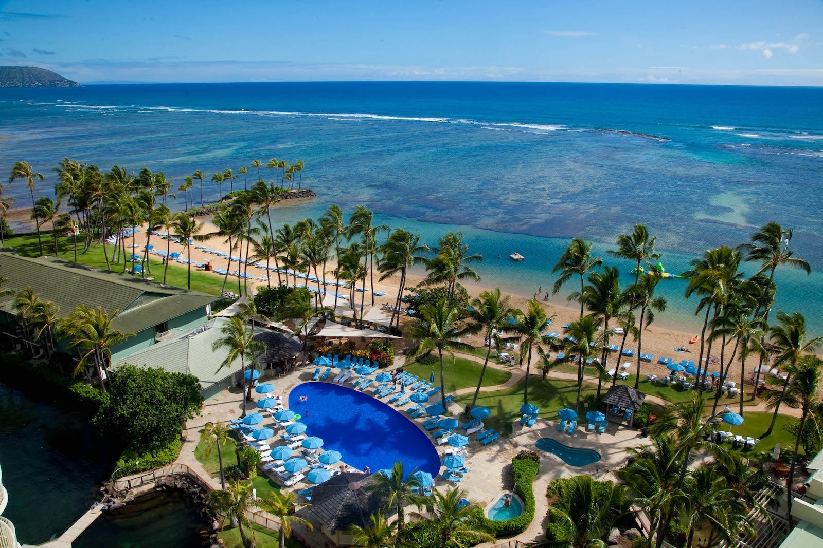 view of swimming pool near beach and turquoise waters of the ocean