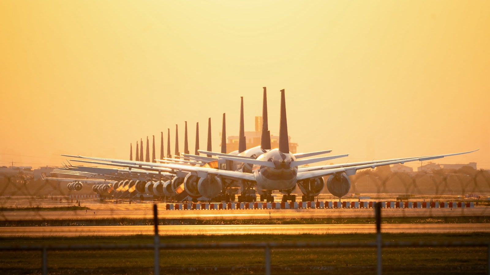 So many airplanes are in line on the runway waiting for take off. These Air Force planes are part of Operation stop service to transport in Covid-19 situation.