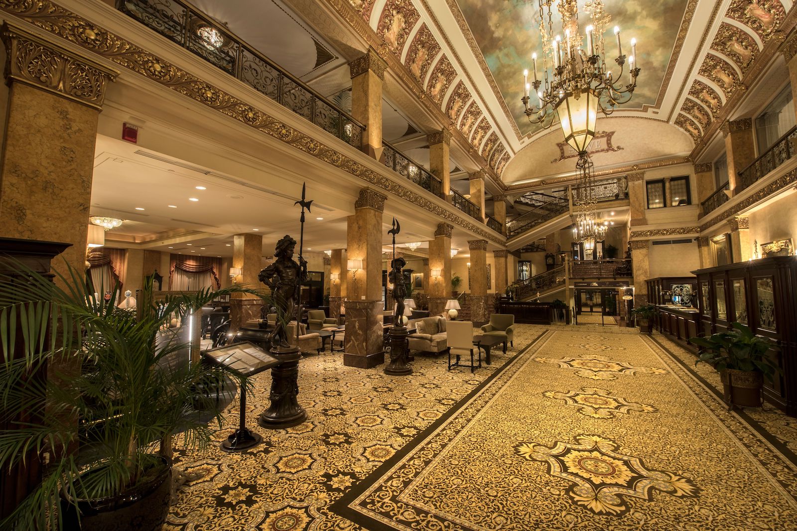 golden, two-level hotel lobby with ornate flooring
