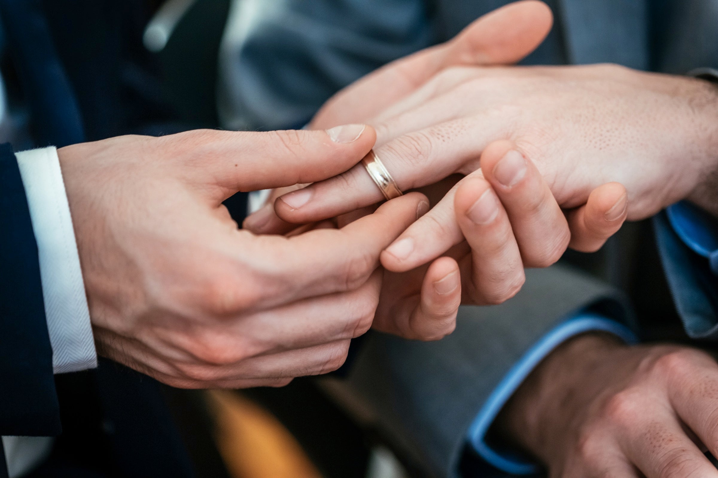 Person putting wedding ring on someone else