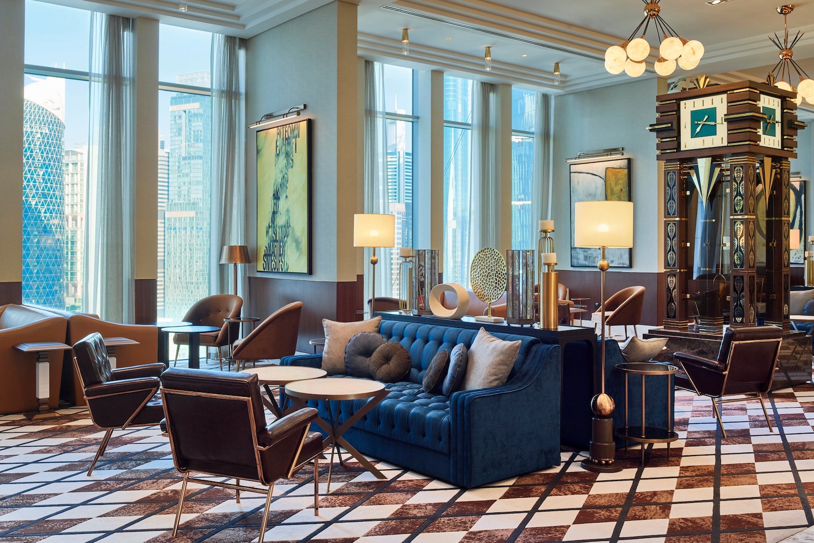 hotel lounge with tile floors, couches, large grandfather clock and floor-to-ceiling windows