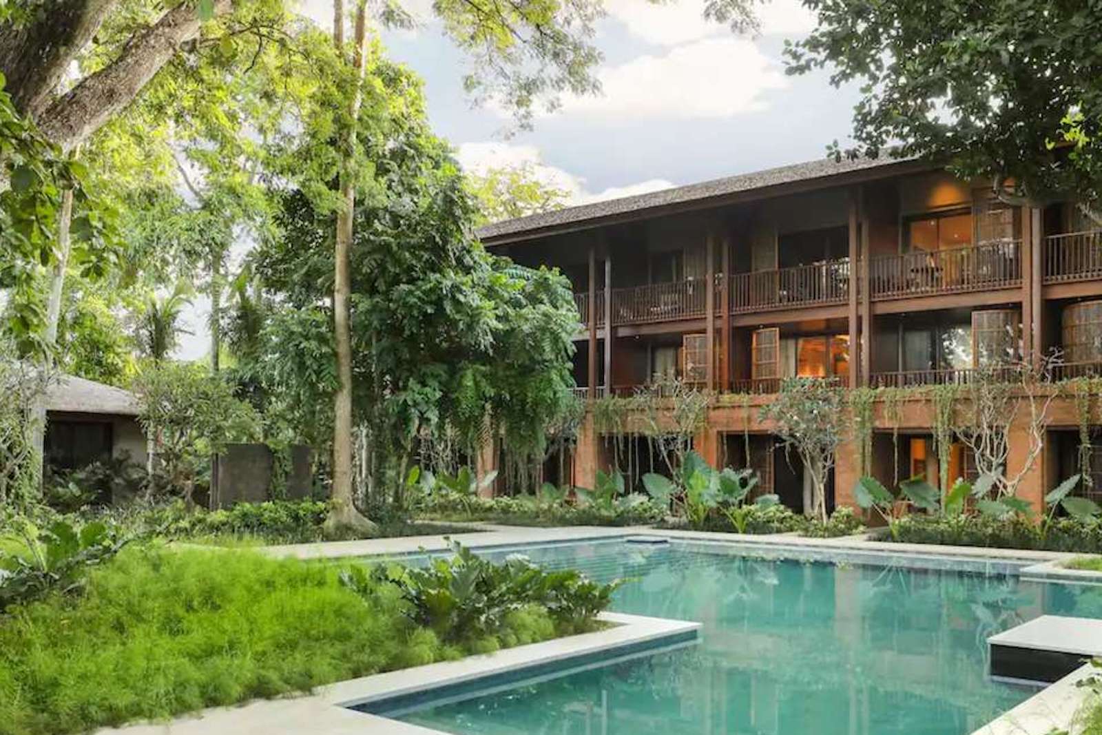 hotel with wooden features and pool