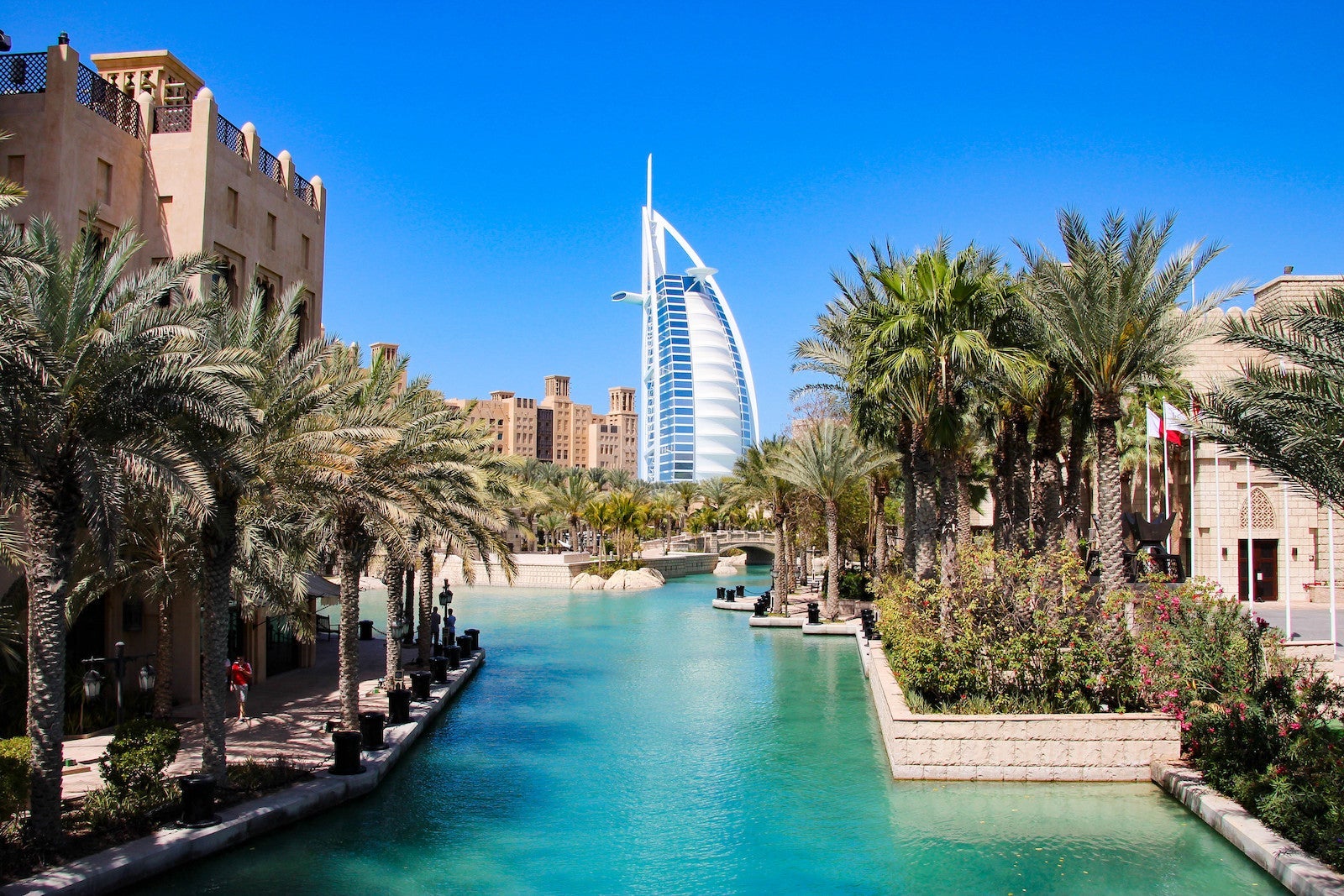 large sail-shaped building looming over canal