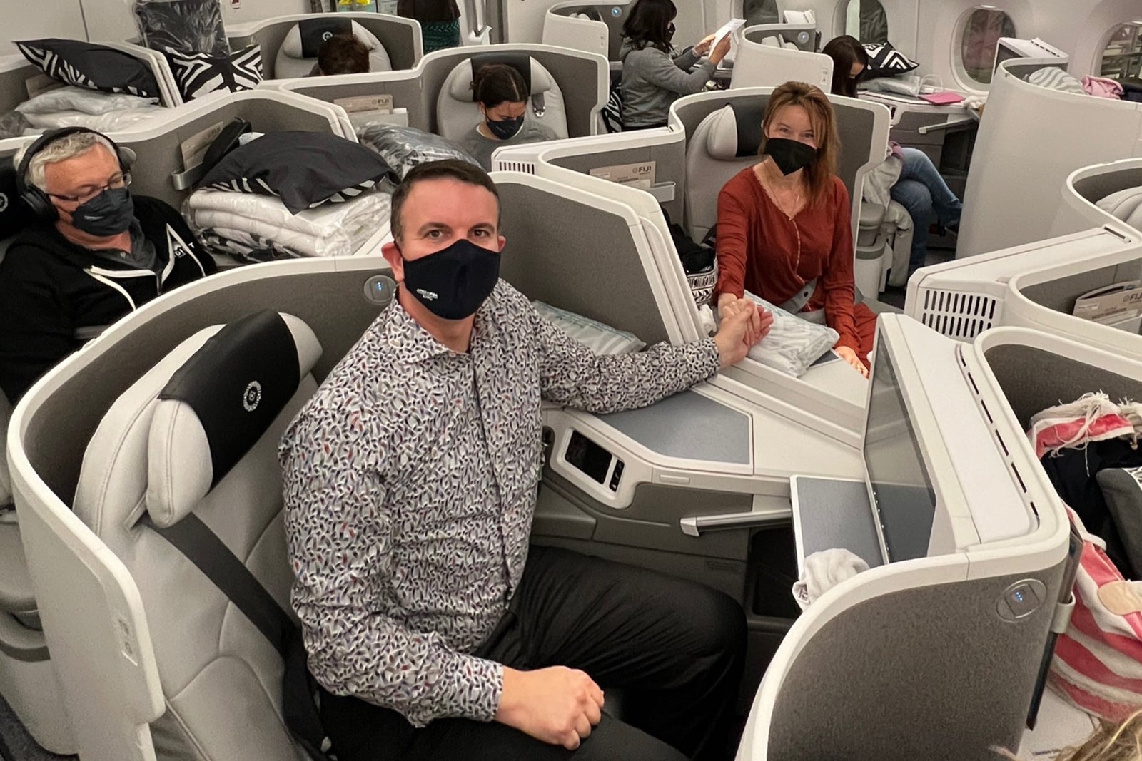 a couple flying in business class on Fiji Airways