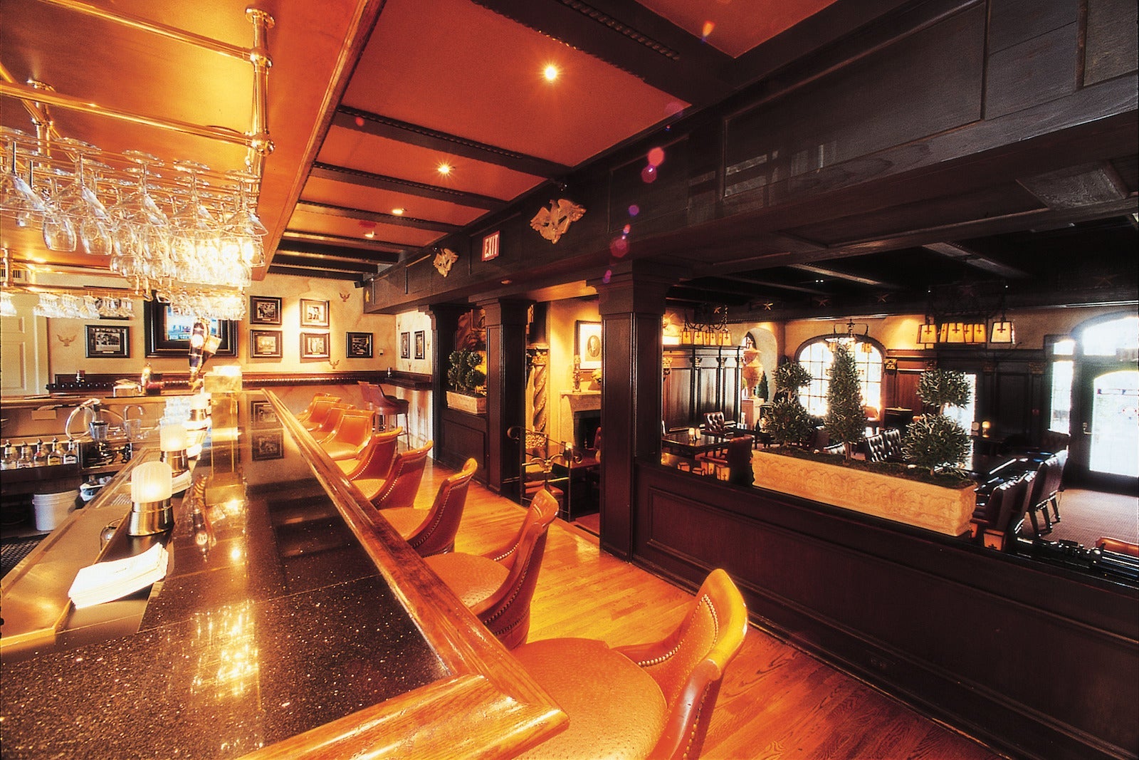 photo of wooden bar with leather bar stools
