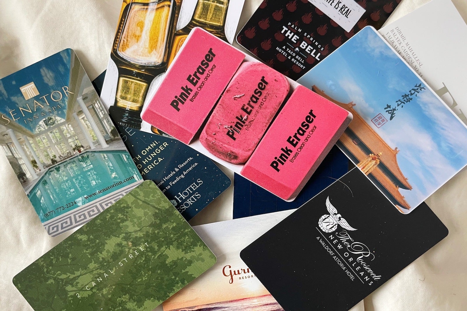 pile of hotel key cards on bed