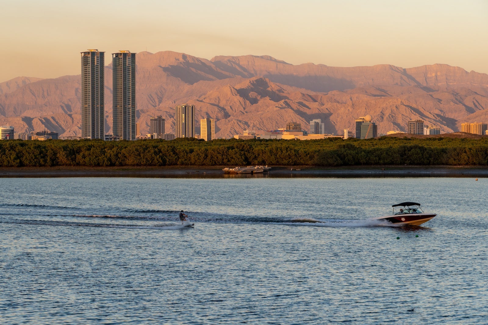 boat pulling water ski with Ras Al Khaimah mountains in the distance