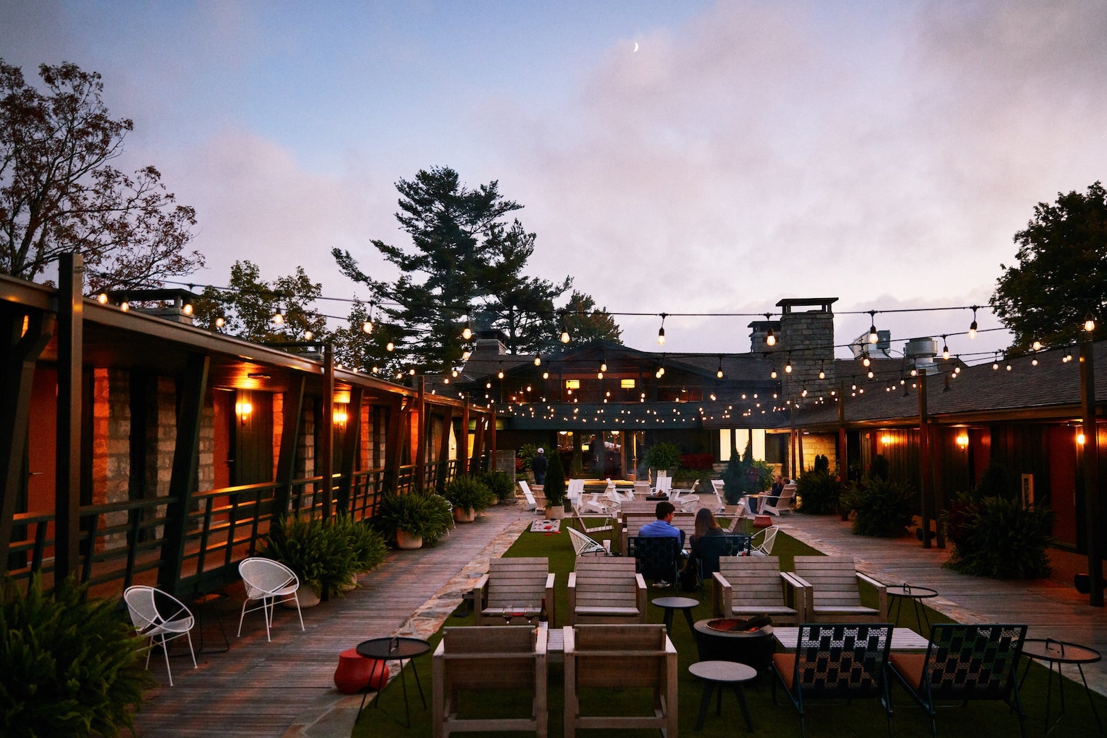 courtyard with strung lights around a u-shaped hotel