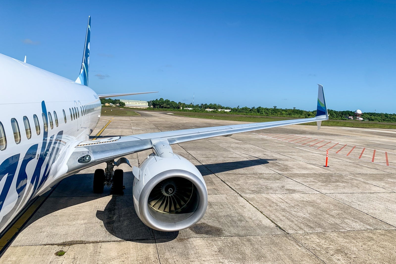 view looking down the side of an Alaska Airlines plane on the tarmac in Belize