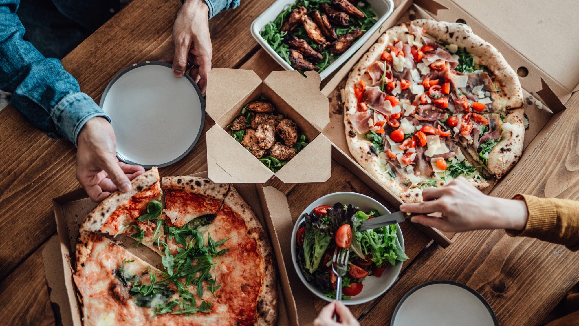 Couple sharing takeaway meal at home