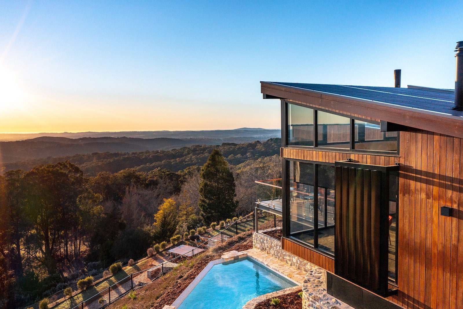 photo of hotel and pool overlooking mountains at dusk