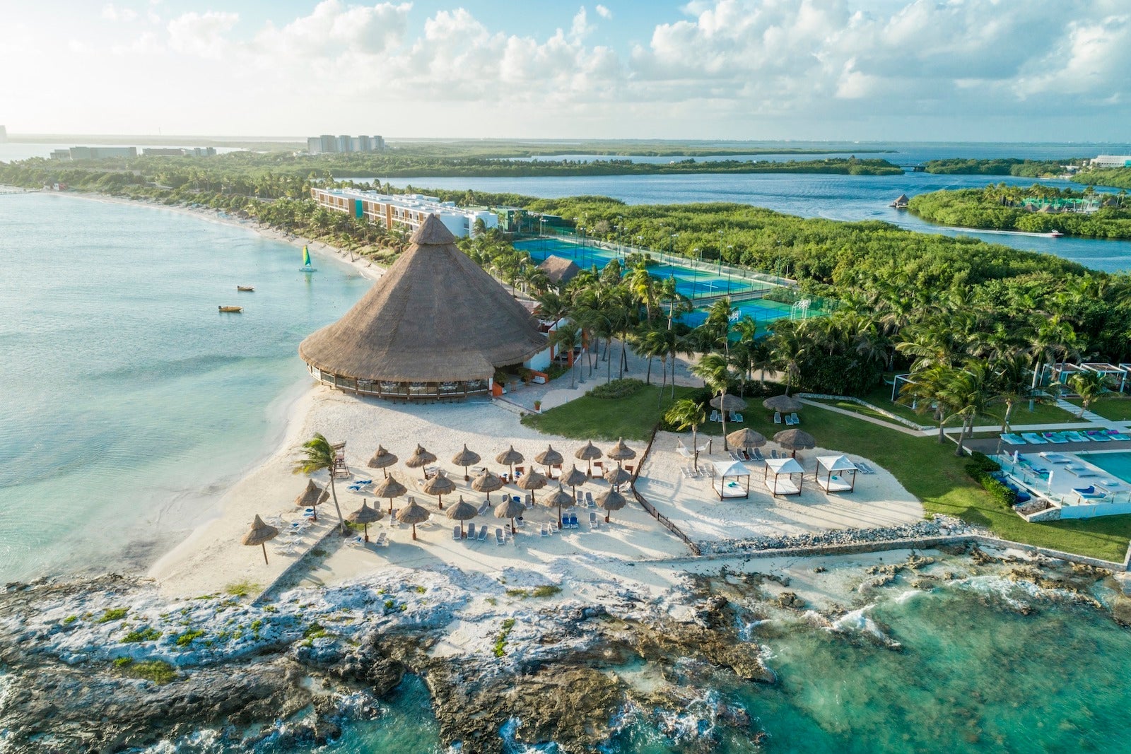 aerial photo of beach resort with large hut building