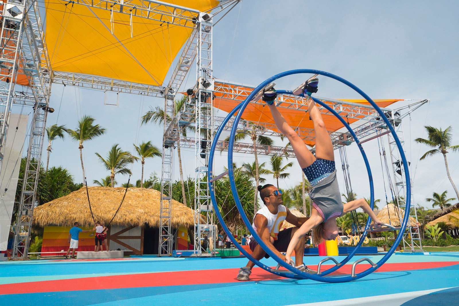 girl in circus equipment rolling upside down