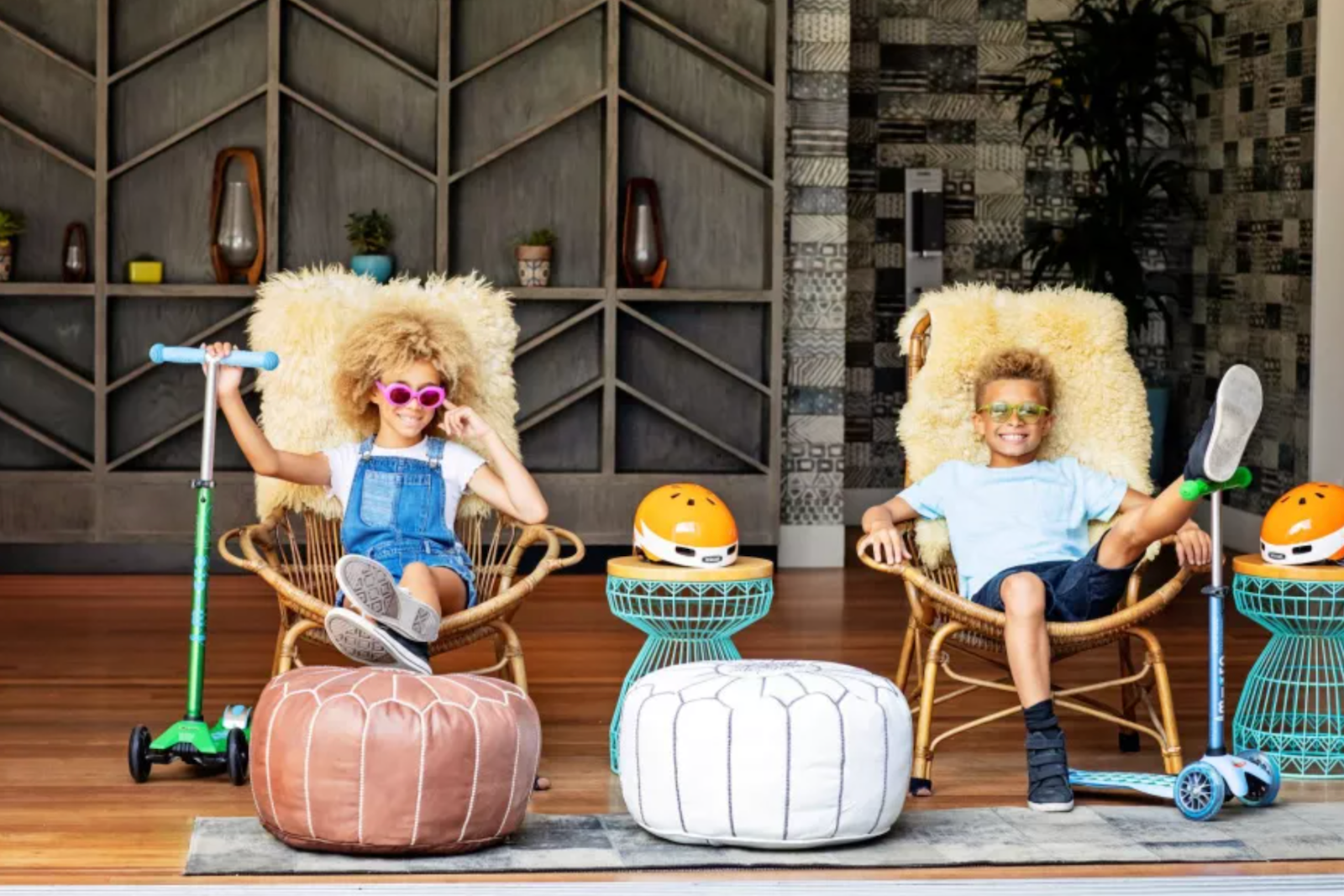 kids sitting in chairs with scooters