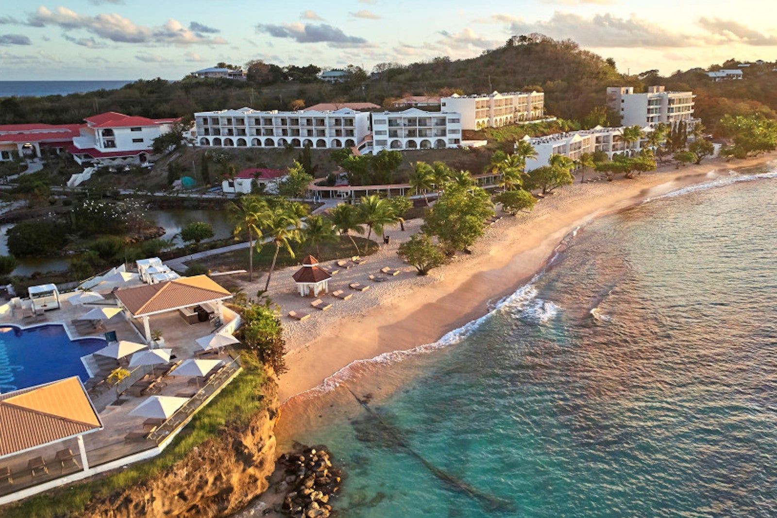 aerial view of lush resort with beach