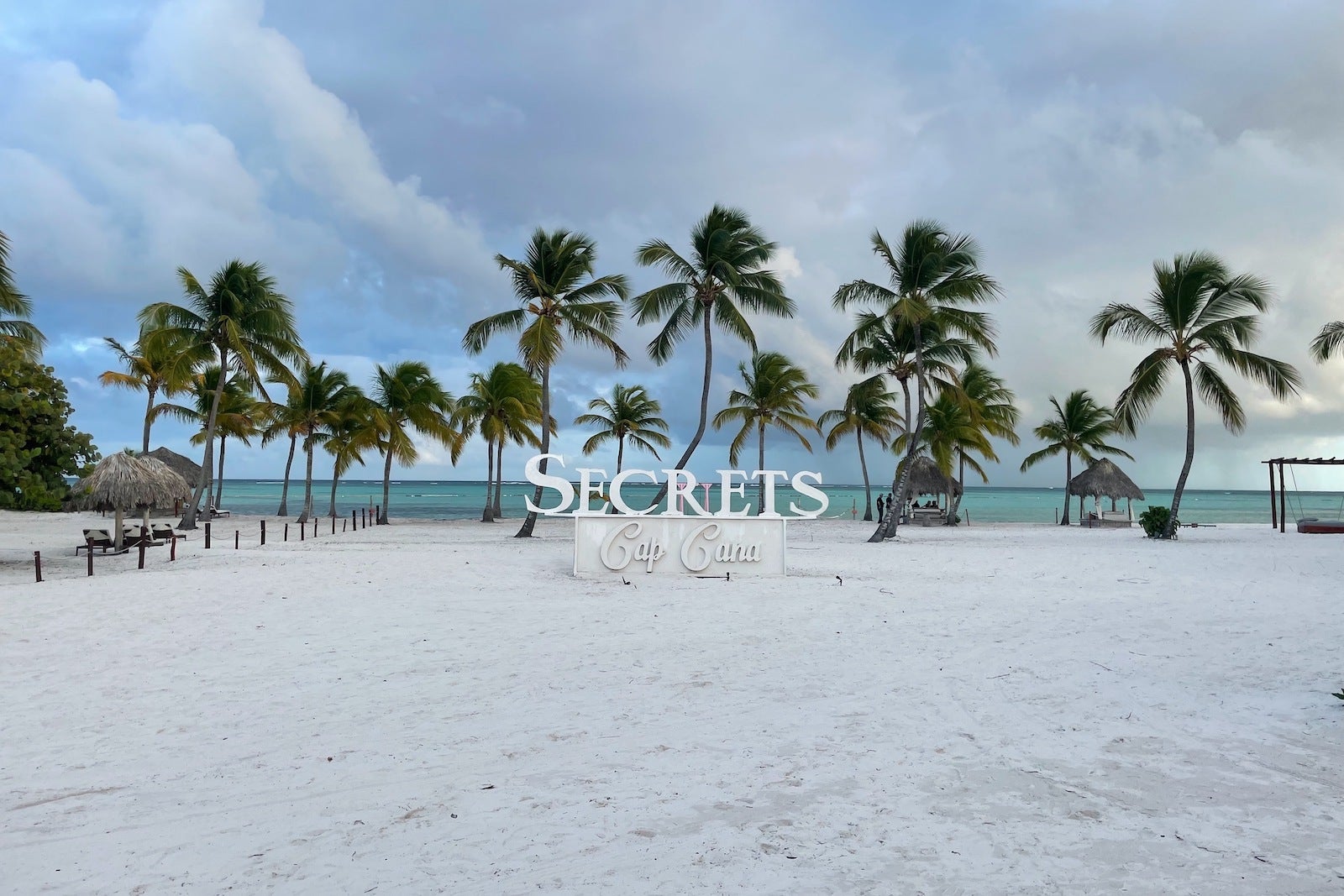Beach with sign and palm trees