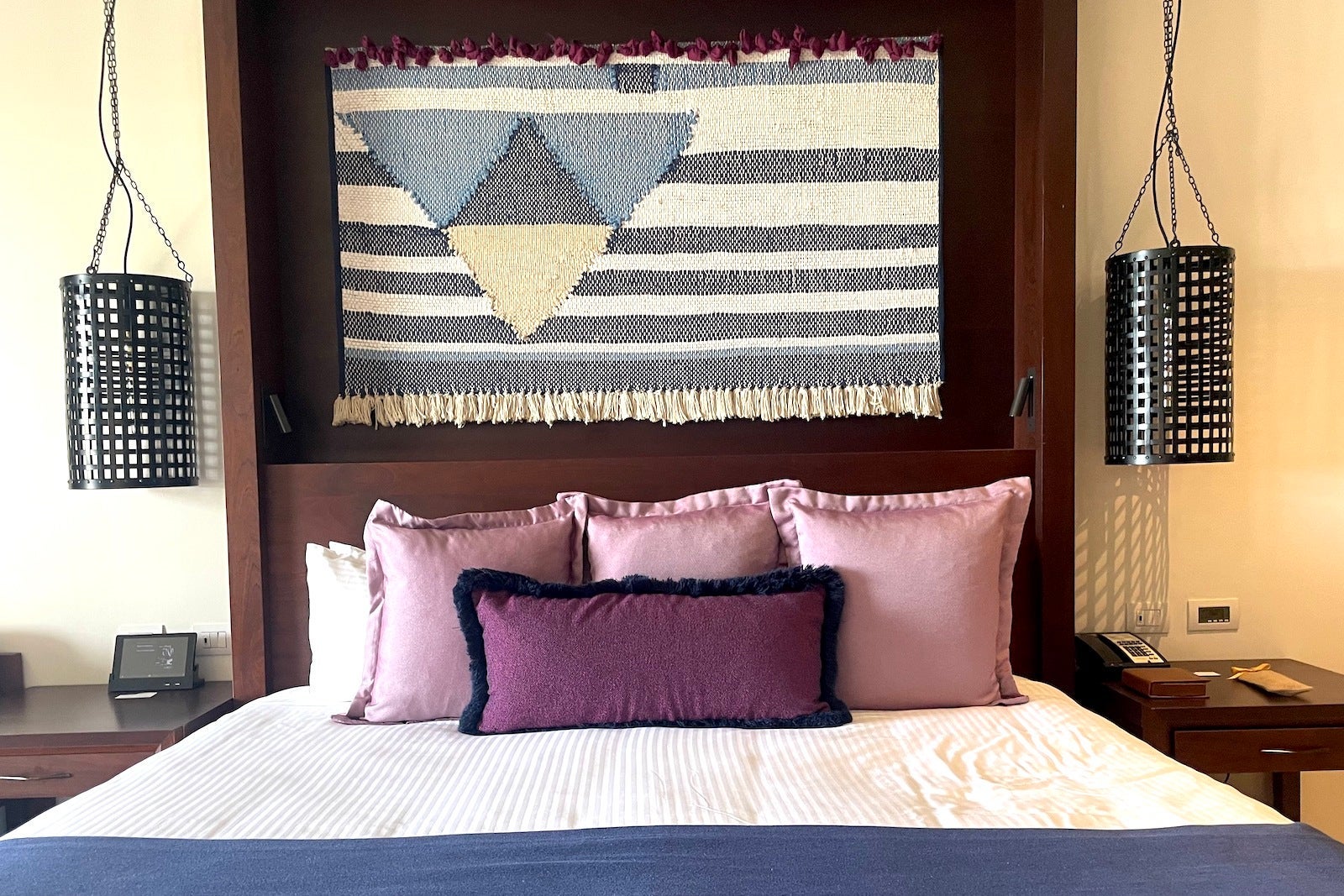 bed with pink pillows and art