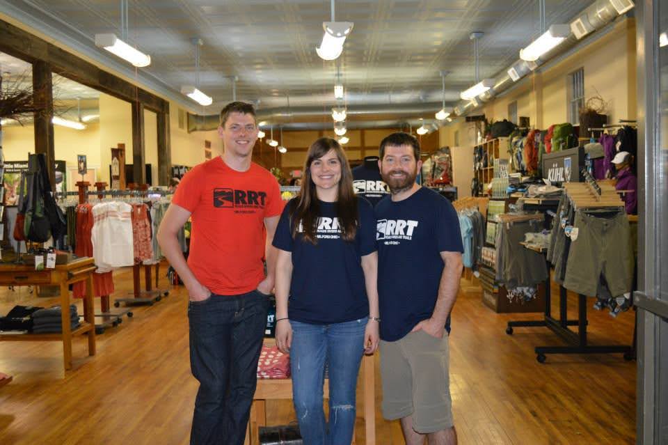 Bryan Wolf and Emily and Joe White inside of their store River Roads and Trails
