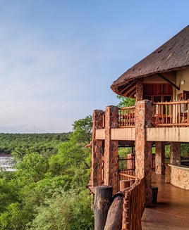 an outdoor seating area at a restaurant looks out over nature