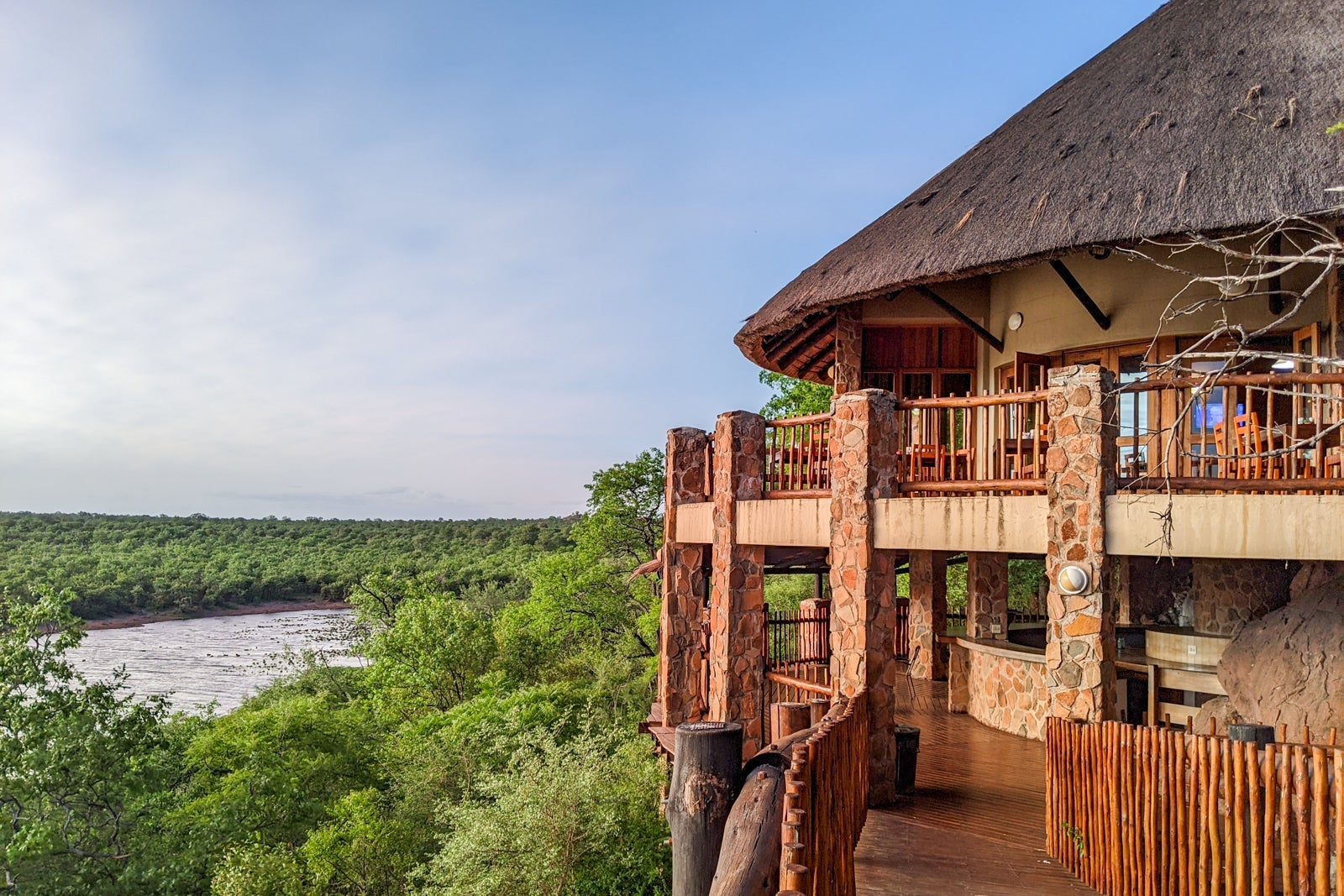 an outdoor seating area at a restaurant looks out over nature