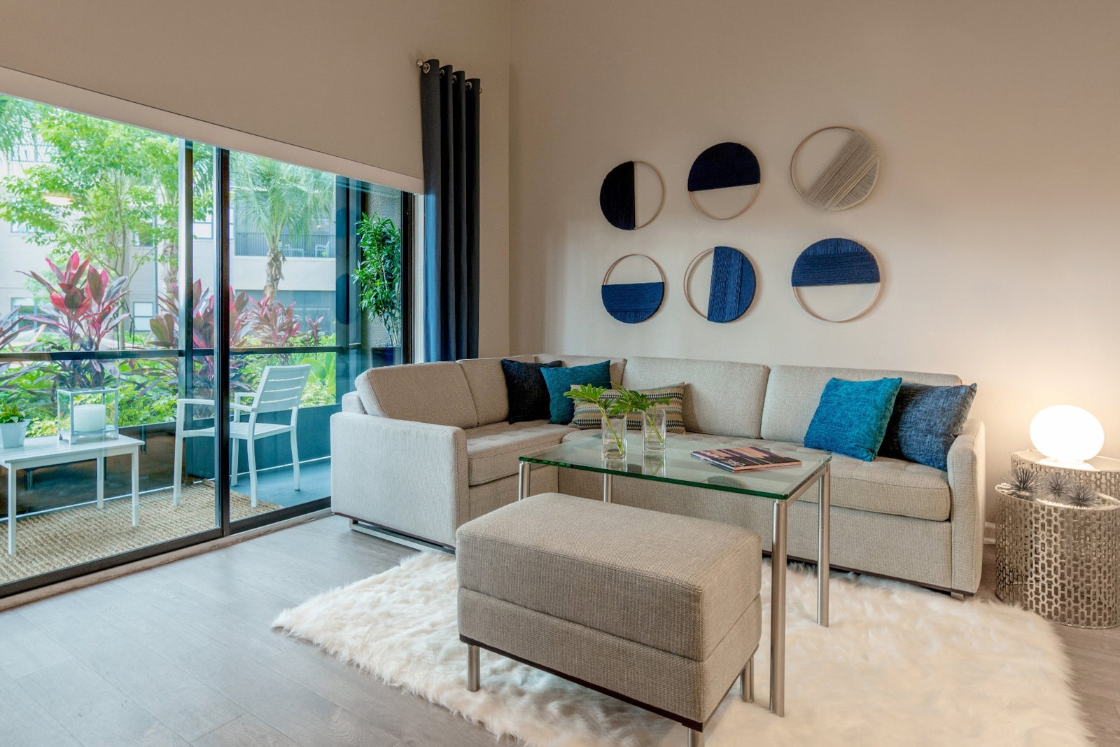 couch, coffee table and view of balcony at The Grove Resort & Water Park