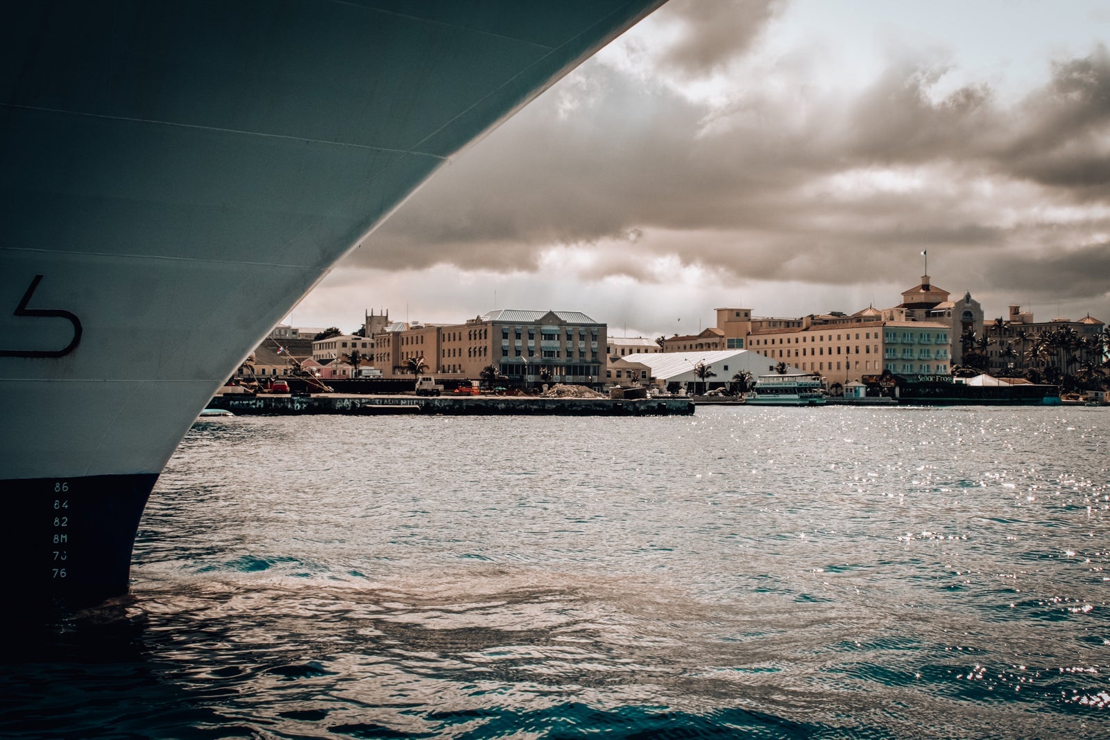 A ship's hill with a Bahamian port in the background