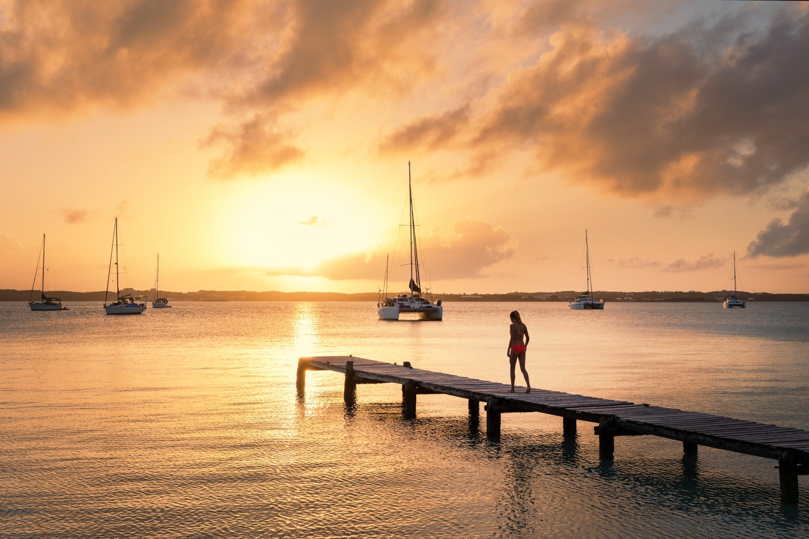 A girl walking on a dock in the Bahamas