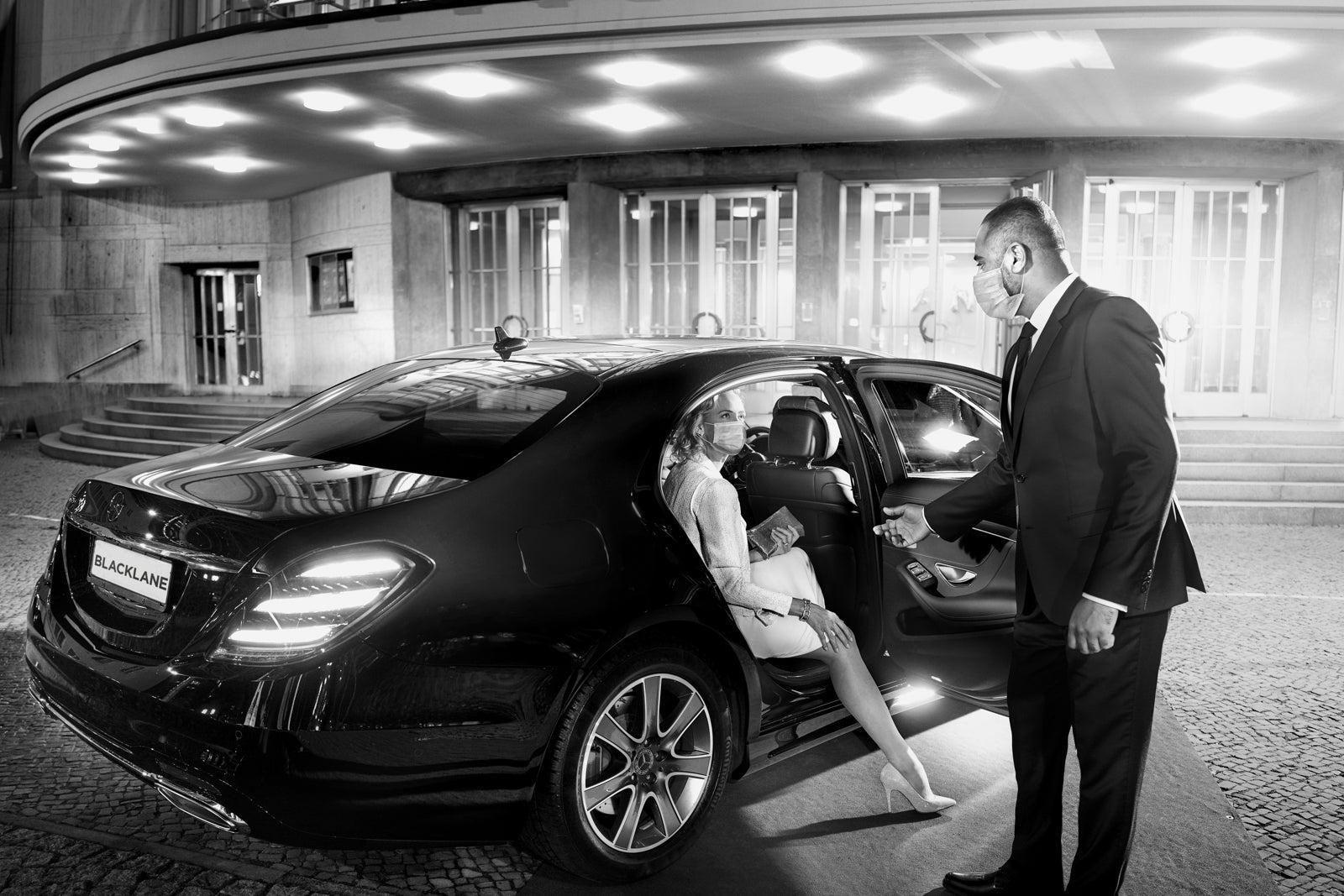 Chauffeur driver assists passenger