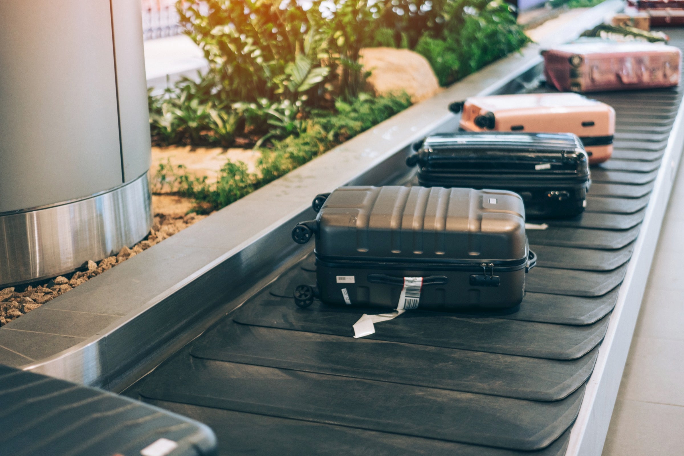 Checked bags on the conbeyor belt at Singapore Airport