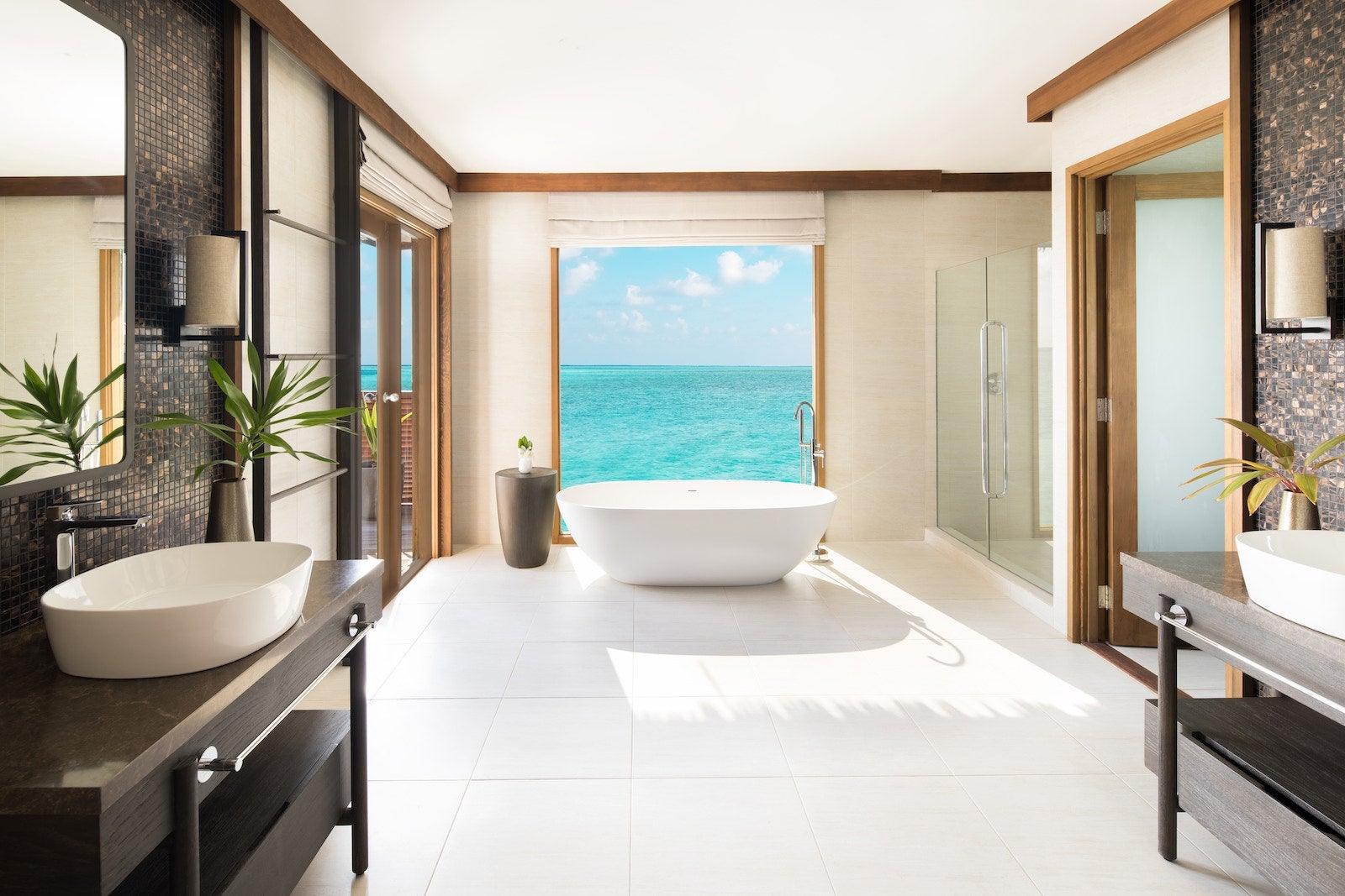 bathtub by window in bathroom looking out at ocean