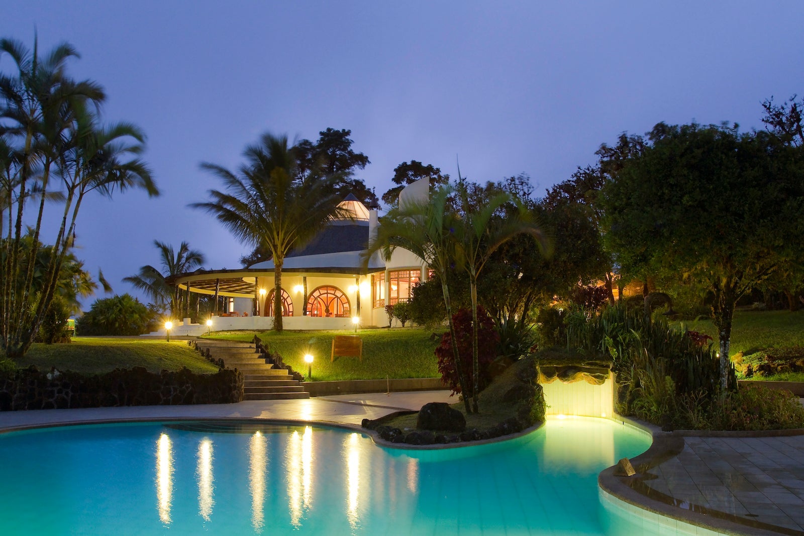 pool at dusk with villa in the background