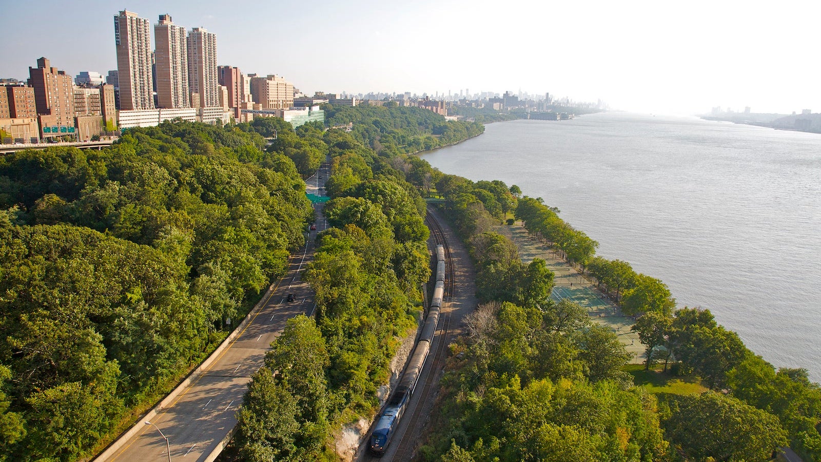 Aerial view of Upper West Side and Riverside Park, with Amtrak train below, from George Washington Bridge, New York, NY, U.S.A.