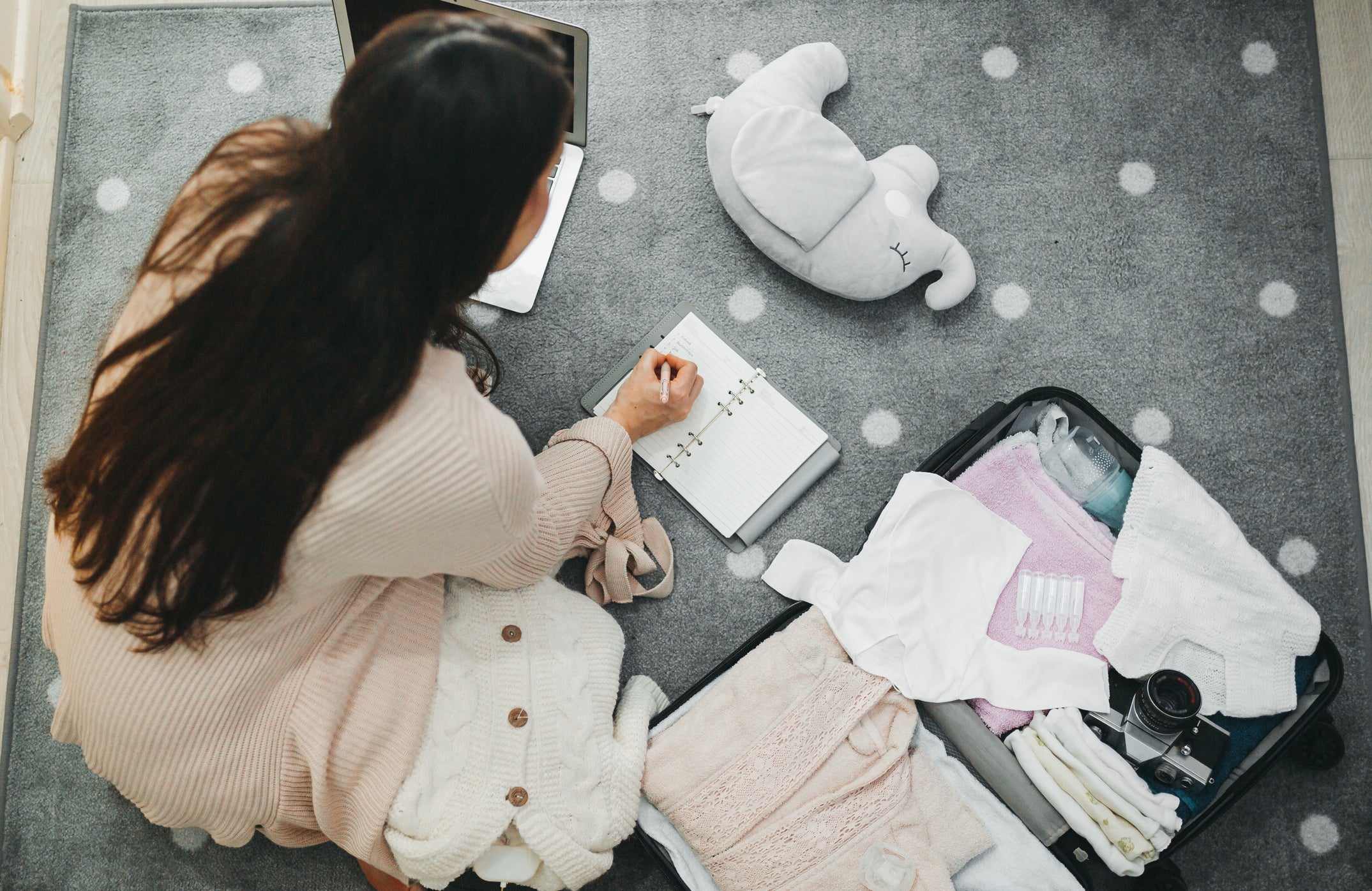 a mom packing baby's suitcase