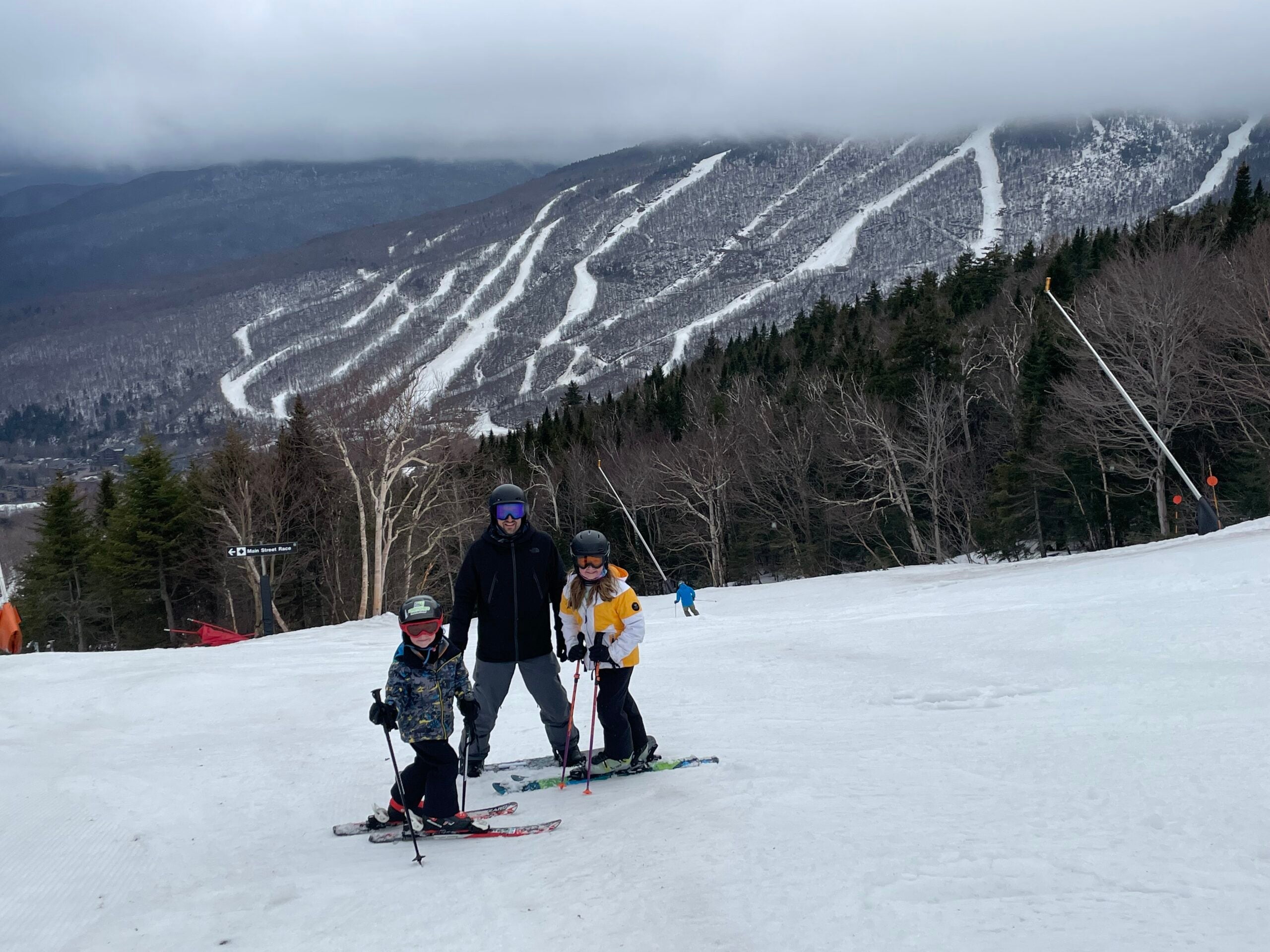 A father and two children skiing at Stowe Mountain, Vermont