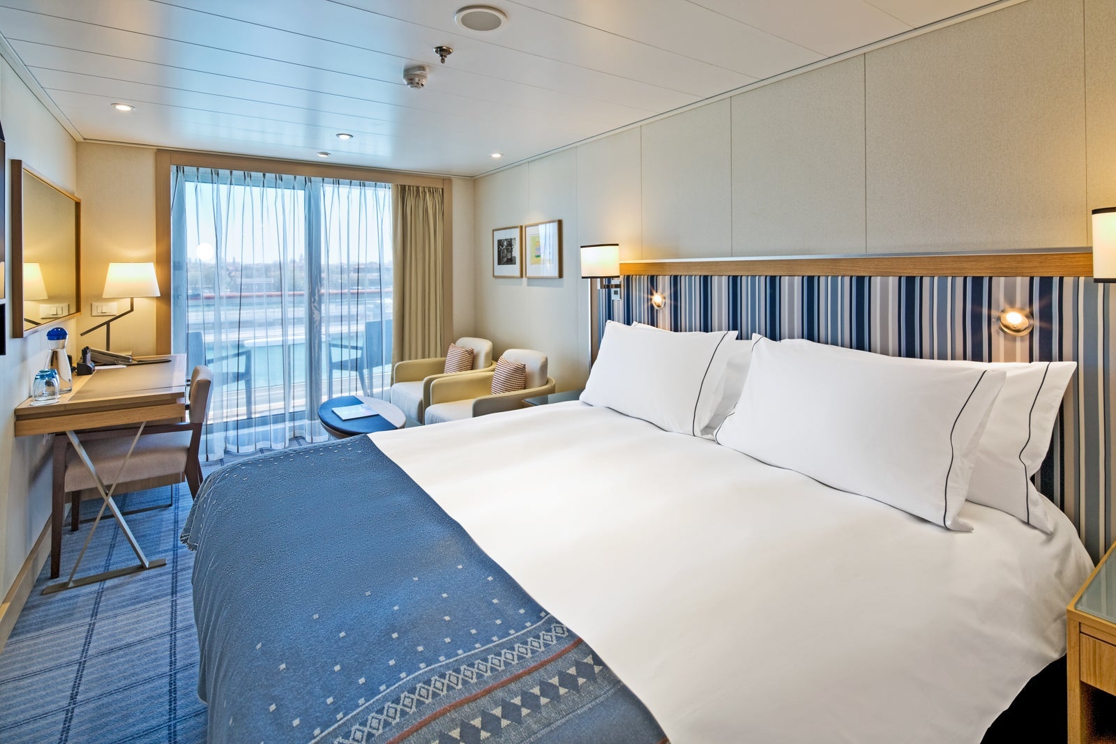 Cruise cabin with large bed and balcony on Viking ship