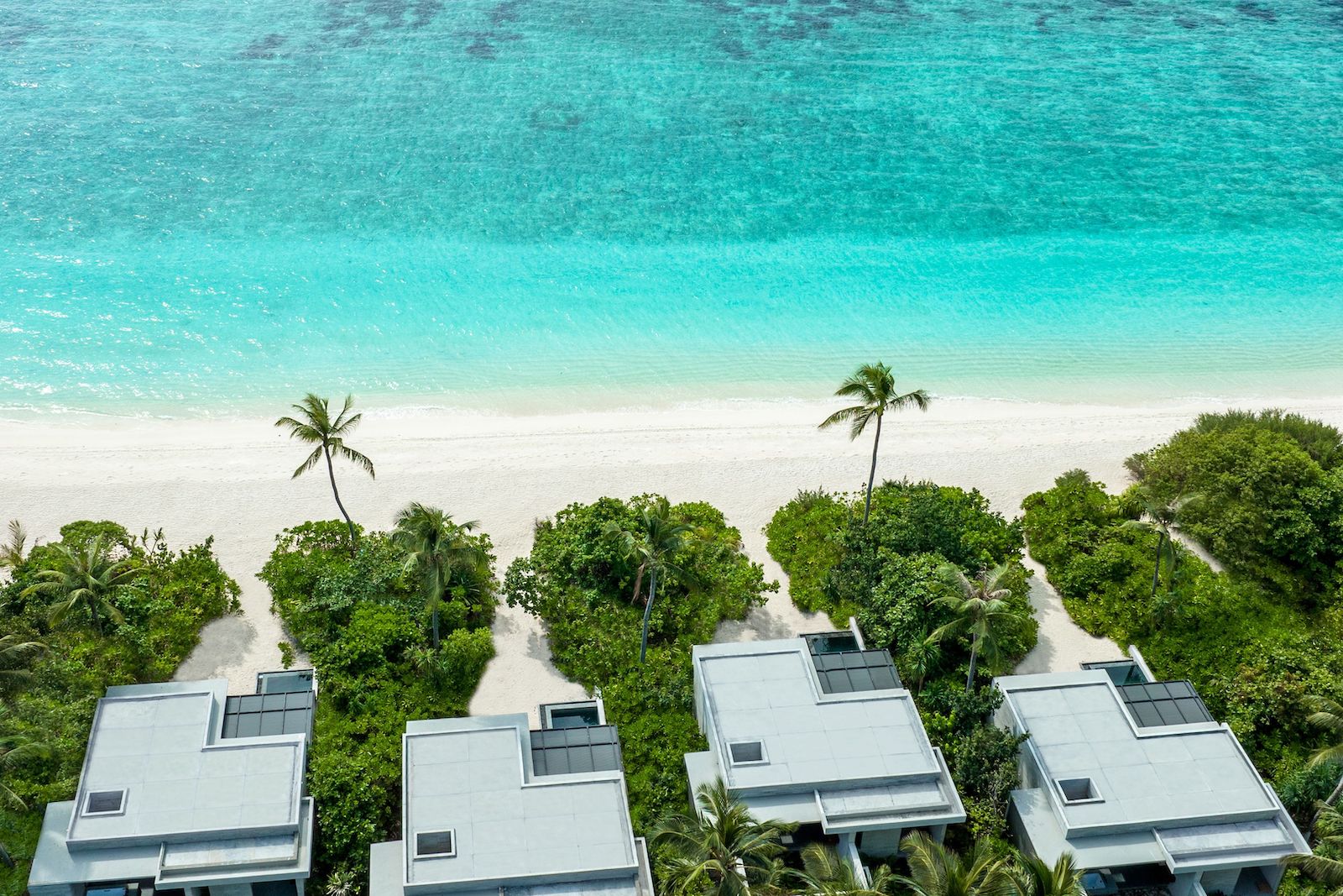 aerial view of turquoise beach, white sand beach and villas