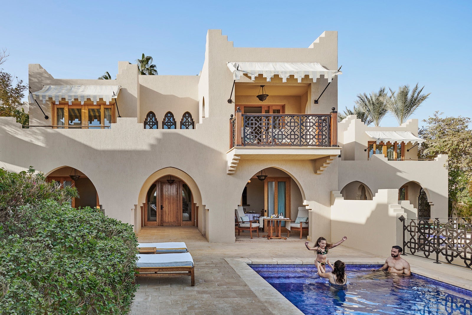 large Arabic-style suite with people swimming in pool