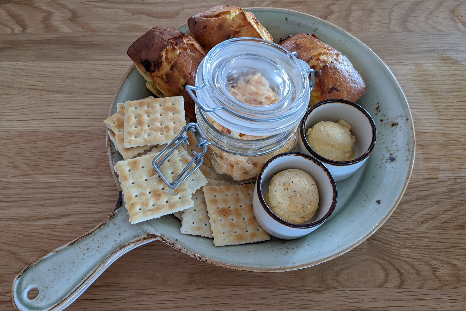 Jalapeno cornbread and Saltines around jar of cheese spread