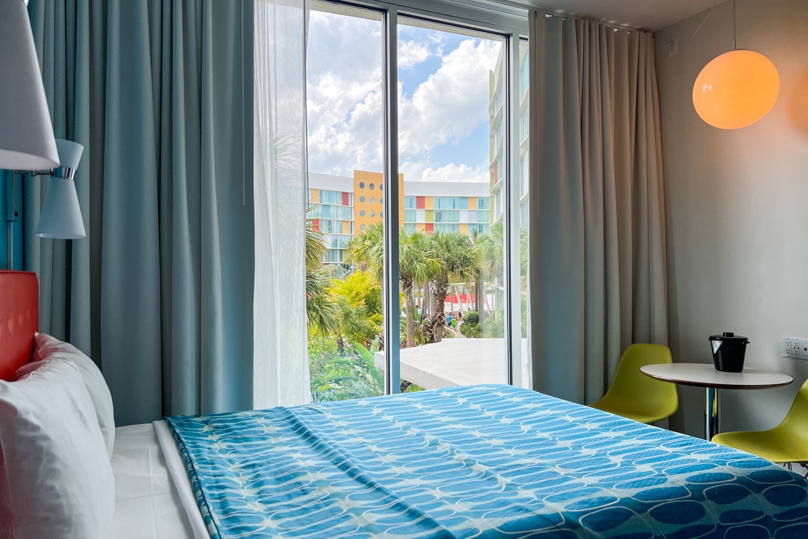 A bed and a view overlooking the pool.