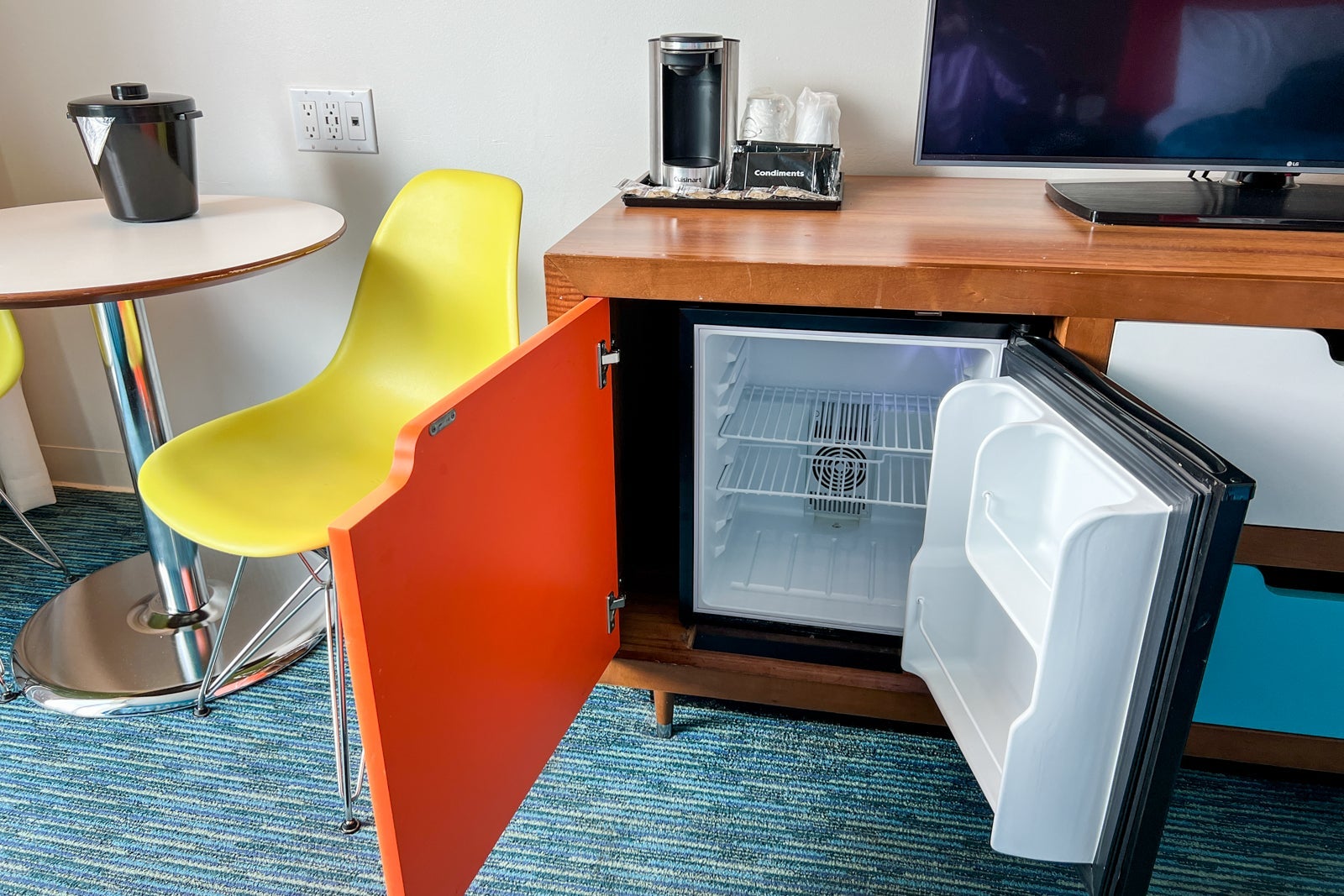 A mini-fridge open in the hotel room.