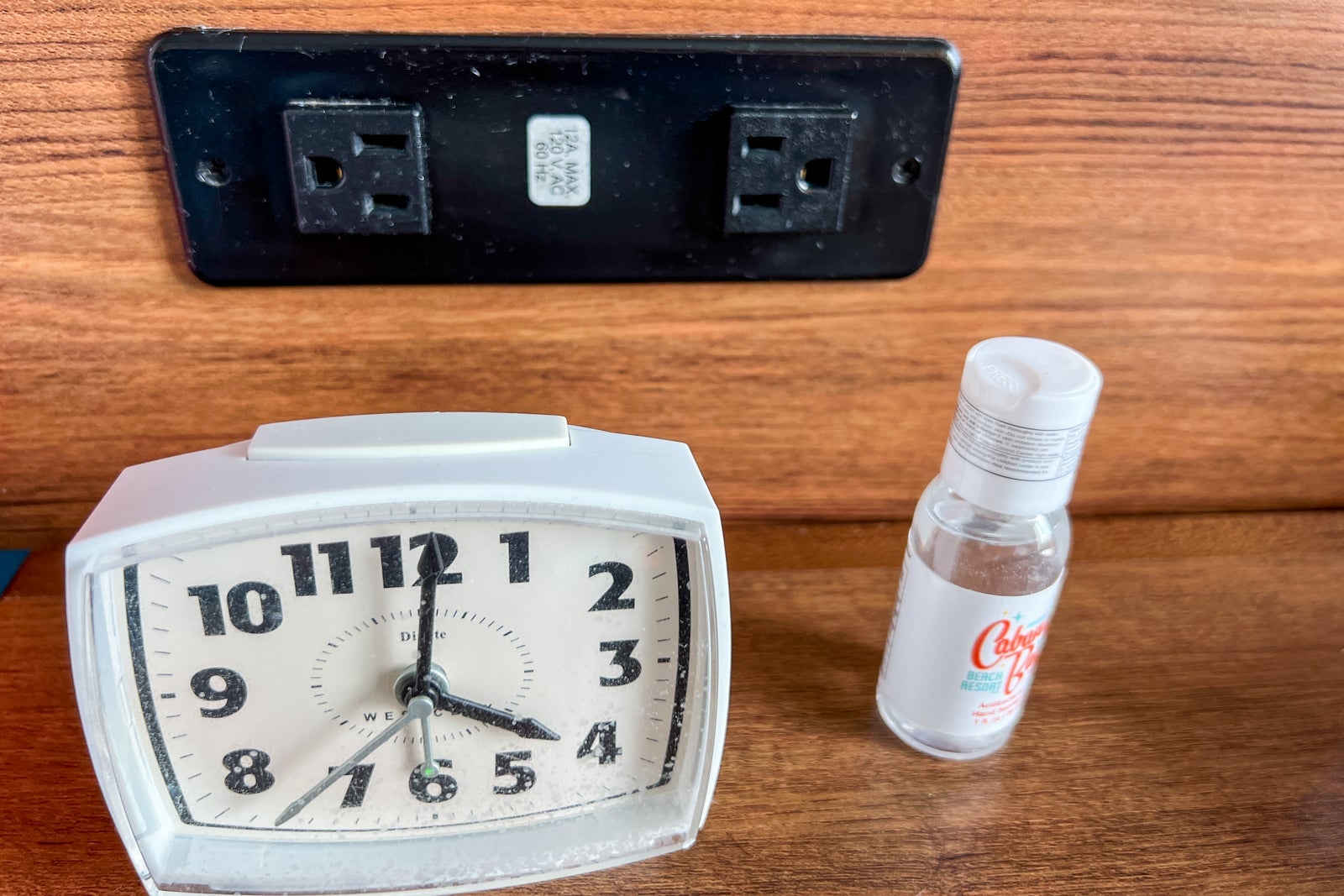 A retro alarm clock and some hand sanitizer.