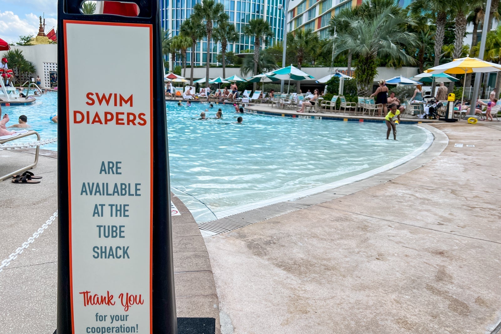 The zero-entry pool with a sign asking parents to have kids in swim diapers.