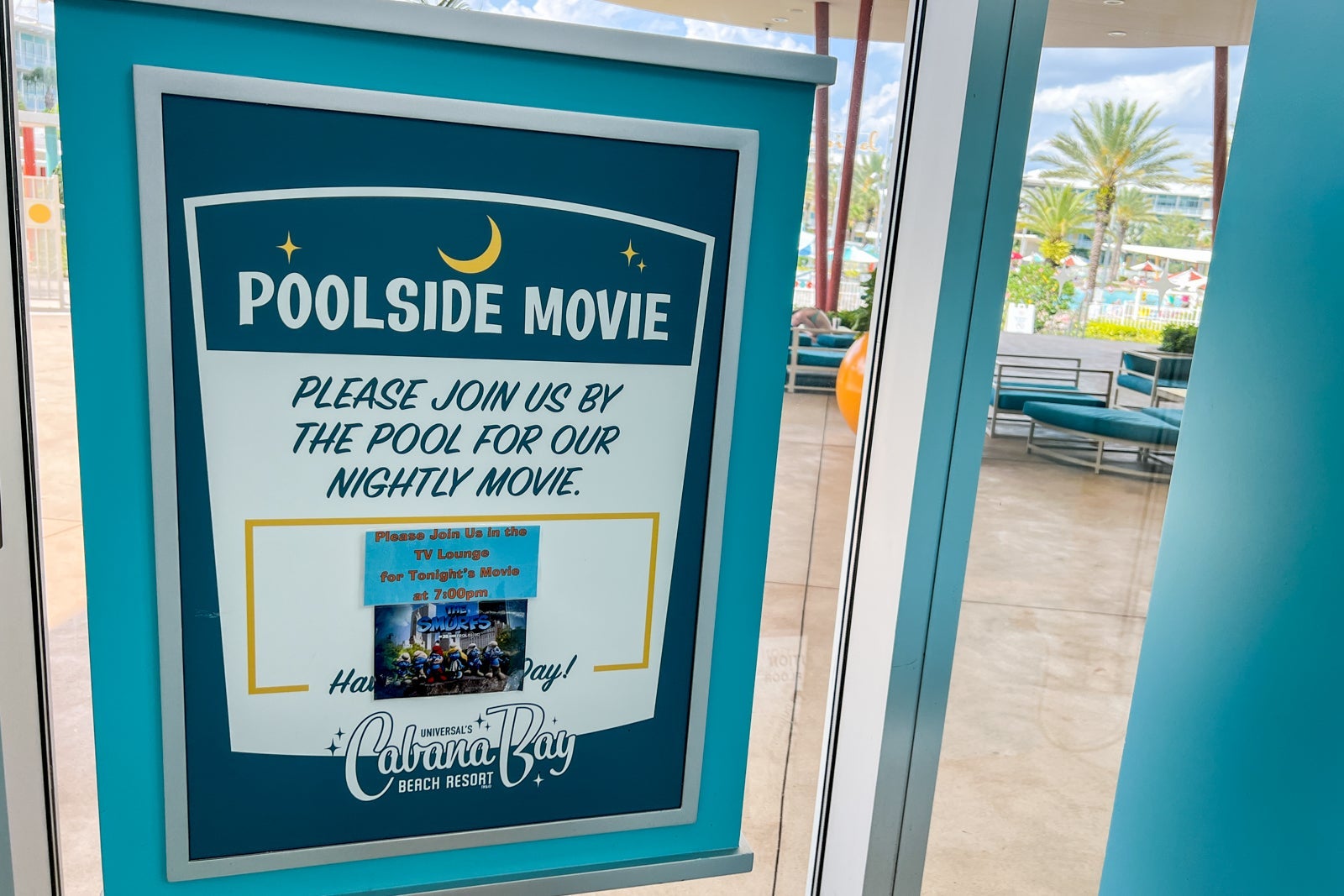 A sign announcing the nighty poolside movies.